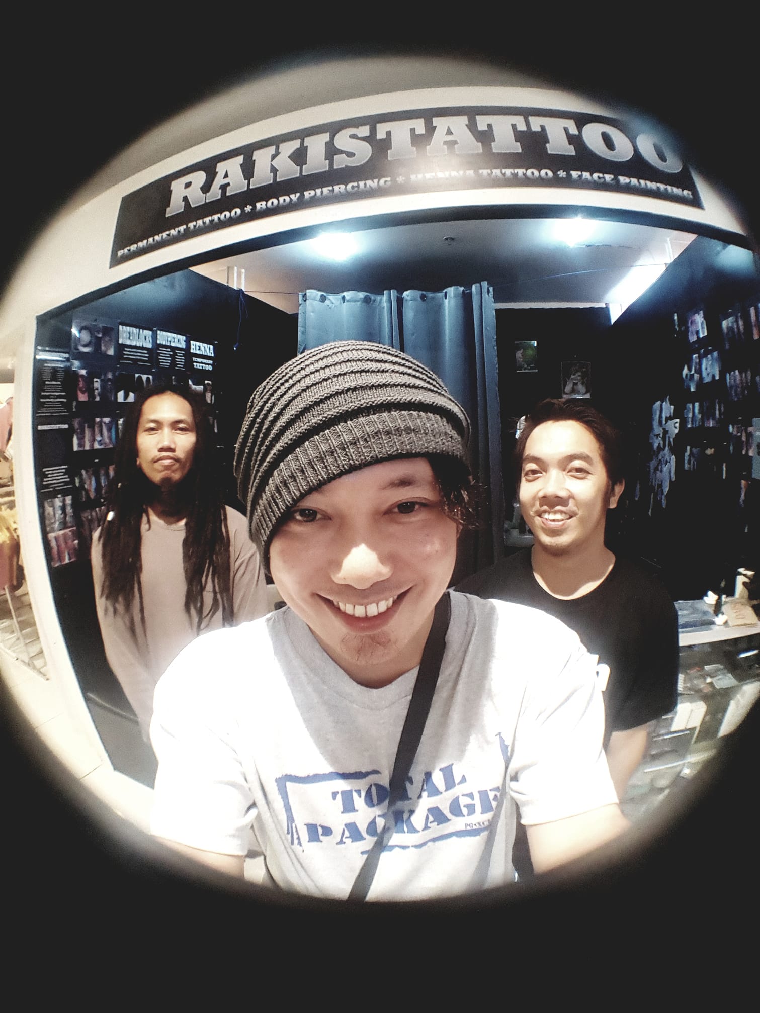 Rakistattoo artists smiling in front of the studio at Ayala Malls Feliz