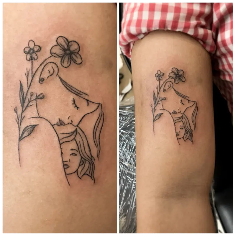 black and grey minimalist linework tattoo of mother and daughter