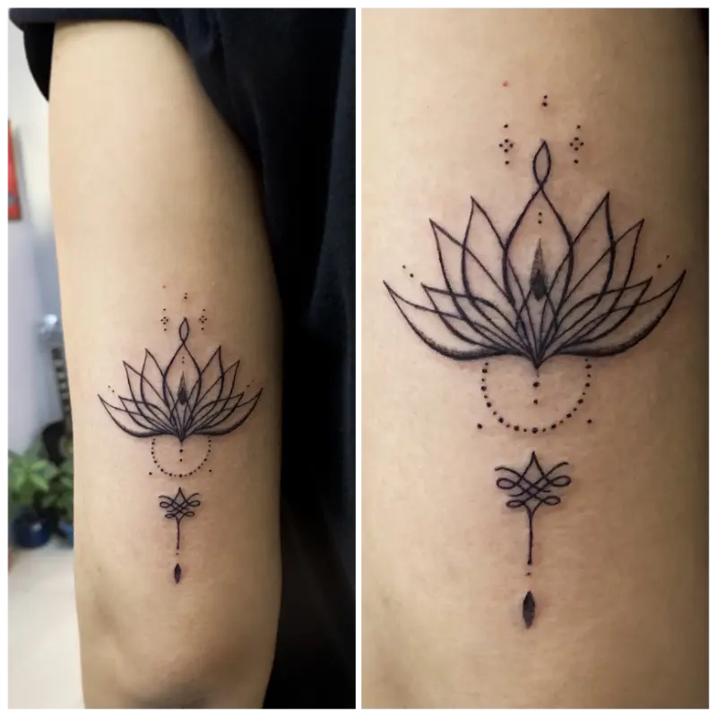 black and grey minimalist tattoo linework of lotus flower
