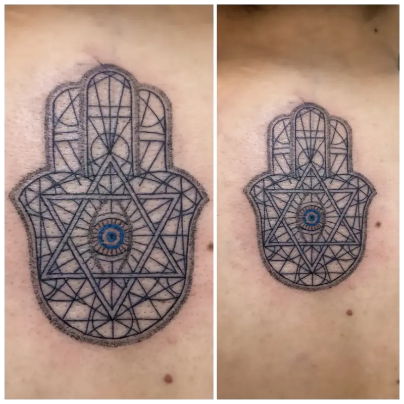 geometric hamsa hand with evil eye tattoo
